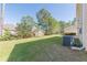 Lush backyard featuring a well-maintained lawn and mature trees, creating a private outdoor space at 4310 Alysheba Dr, Fairburn, GA 30213