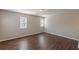 Bedroom featuring hardwood floors, neutral walls and two large windows at 4310 Alysheba Dr, Fairburn, GA 30213