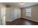 Inviting bedroom boasts wood-look floors, closet, and window for natural light, offering comfort and style at 4310 Alysheba Dr, Fairburn, GA 30213