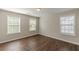 Bedroom with hardwood flooring and three windows at 4310 Alysheba Dr, Fairburn, GA 30213