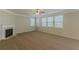 Large carpeted primary bedroom featuring a fireplace and multiple windows for ample natural light at 4310 Alysheba Dr, Fairburn, GA 30213
