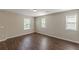 Bedroom featuring hardwood floors, neutral walls and three large windows at 4310 Alysheba Dr, Fairburn, GA 30213