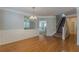 Spacious dining area with hardwood floors and decorative wall trim, featuring a view into the living room at 4310 Alysheba Dr, Fairburn, GA 30213