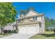 Lovely exterior view of a two-story home featuring a two-car garage and well-maintained landscaping at 4310 Alysheba Dr, Fairburn, GA 30213