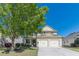 Inviting two-story home with a well-manicured lawn, mature tree, and a convenient two-car garage at 4310 Alysheba Dr, Fairburn, GA 30213