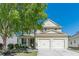 Charming two-story home featuring a well-manicured lawn, mature trees, and a convenient two-car garage at 4310 Alysheba Dr, Fairburn, GA 30213