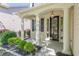Inviting front porch with classic columns, detailed trim, and a beautifully landscaped garden bed at 4310 Alysheba Dr, Fairburn, GA 30213