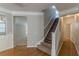 Hallway with hardwood floors and staircase leading to upper level, with access to other rooms at 4310 Alysheba Dr, Fairburn, GA 30213