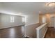 Hallway featuring hardwood floors, neutral walls, natural light and access to other rooms at 4310 Alysheba Dr, Fairburn, GA 30213