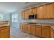 Kitchen featuring granite countertops, gas range, tile flooring and ample cabinetry at 4310 Alysheba Dr, Fairburn, GA 30213