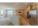 Beautiful kitchen with stainless steel appliances, granite countertops, and view to living room with glass door and carpet at 4310 Alysheba Dr, Fairburn, GA 30213