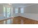 Bright living room with hardwood floors, wainscoting detail, and large french doors at 4310 Alysheba Dr, Fairburn, GA 30213