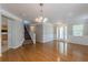 Bright and airy living room with hardwood floors, wainscoting, and staircase to the upper level at 4310 Alysheba Dr, Fairburn, GA 30213
