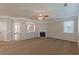 Spacious living room with a fireplace and view of other rooms through an open wall at 4310 Alysheba Dr, Fairburn, GA 30213