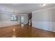 Spacious living room featuring hardwood floors, wainscoting, crown molding and ample natural light at 4310 Alysheba Dr, Fairburn, GA 30213