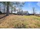Spacious backyard featuring mature trees, lush greenery, and fencing at 923 Wexford Way, Auburn, GA 30011