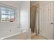 Bright bathroom featuring soaking tub under a window with a view and a separate shower at 923 Wexford Way, Auburn, GA 30011