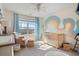 Bright Bedroom featuring modern decor, a crib, and natural light at 923 Wexford Way, Auburn, GA 30011