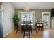 The dining area features a modern chandelier, a view to the yard, and convenient access to the back door at 923 Wexford Way, Auburn, GA 30011