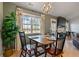 A spacious dining area features a table set for four, large windows, and access to other parts of the home at 923 Wexford Way, Auburn, GA 30011
