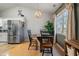 Bright dining area features a charming table set, a modern chandelier, and a view to the backyard at 923 Wexford Way, Auburn, GA 30011