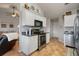 A well-lit kitchen with stainless steel appliances, white cabinetry, and modern fixtures for a sleek design at 923 Wexford Way, Auburn, GA 30011