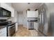 Modern kitchen with stainless steel appliances, granite countertops, and white cabinets for a clean and stylish look at 923 Wexford Way, Auburn, GA 30011