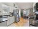This kitchen and dining area features stainless steel appliances, granite countertops, and a modern lighting fixture at 923 Wexford Way, Auburn, GA 30011