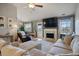 Cozy living room with a fireplace, comfortable seating, and view into the dining area at 923 Wexford Way, Auburn, GA 30011
