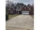 Charming brick home with a two-car garage and long driveway at 1630 Stonehaven, Cumming, GA 30040