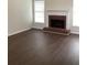 Spacious living room features a brick fireplace, large windows, and hardwood floors at 1630 Stonehaven, Cumming, GA 30040