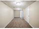 Finished basement area with multiple doors and neutral carpeting at 1826 Meadowglades Dr, Decatur, GA 30035