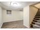 Finished basement with carpet, window, and stairs at 1826 Meadowglades Dr, Decatur, GA 30035