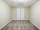 A clean basement bedroom with neutral walls, carpeting, and double bi-fold closet at 1826 Meadowglades Dr, Decatur, GA 30035