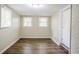 Bedroom featuring hardwood flooring, two windows, and neutral paint at 1826 Meadowglades Dr, Decatur, GA 30035