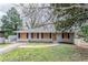 Charming single-story home with gray brick, dark shutters, and front lawn at 1826 Meadowglades Dr, Decatur, GA 30035