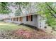 Gray brick single-story home with dark shutters, and lawn on a cloudy day at 1826 Meadowglades Dr, Decatur, GA 30035