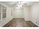 Bright living room with wood floors, ceiling fan, and windows with privacy blinds at 1826 Meadowglades Dr, Decatur, GA 30035