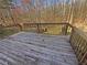 Wooden back deck overlooking a private wooded backyard with mature trees and natural landscaping at 1997 Alcovy Trace Way, Lawrenceville, GA 30045