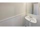 Powder room featuring a stylish pedestal sink and wainscoting at 1997 Alcovy Trace Way, Lawrenceville, GA 30045