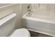 Bathroom featuring a white toilet and bathtub at 1997 Alcovy Trace Way, Lawrenceville, GA 30045