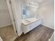 Bright bathroom featuring a double vanity and large mirror reflecting a soaking tub at 1997 Alcovy Trace Way, Lawrenceville, GA 30045