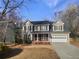 Charming two-story home with beige siding, a dark roof, and a brick porch and garage at 1997 Alcovy Trace Way, Lawrenceville, GA 30045