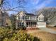 Charming two-story home featuring beige siding, dark roof, and well-maintained landscaping and mature trees at 1997 Alcovy Trace Way, Lawrenceville, GA 30045