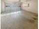 Spacious two car garage featuring a large roll-up door and concrete flooring at 1997 Alcovy Trace Way, Lawrenceville, GA 30045