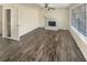 Bright living room featuring new flooring, a fireplace, and a large window with natural light at 1997 Alcovy Trace Way, Lawrenceville, GA 30045