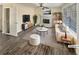 Cozy living room with a fireplace, modern furniture, and ample natural light from the large windows at 1997 Alcovy Trace Way, Lawrenceville, GA 30045