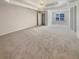 Large primary bedroom with a tray ceiling, ceiling fan, big closet, and natural light from the windows at 1997 Alcovy Trace Way, Lawrenceville, GA 30045