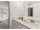 Bathroom vanity featuring double sinks, a stone countertop, and a view to the outside through the doorway at 2206 Loring Ct, Decatur, GA 30032