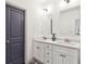 Bright bathroom featuring double sink vanity with quartz counters, white cabinets and decorative grey patterned floors at 2206 Loring Ct, Decatur, GA 30032